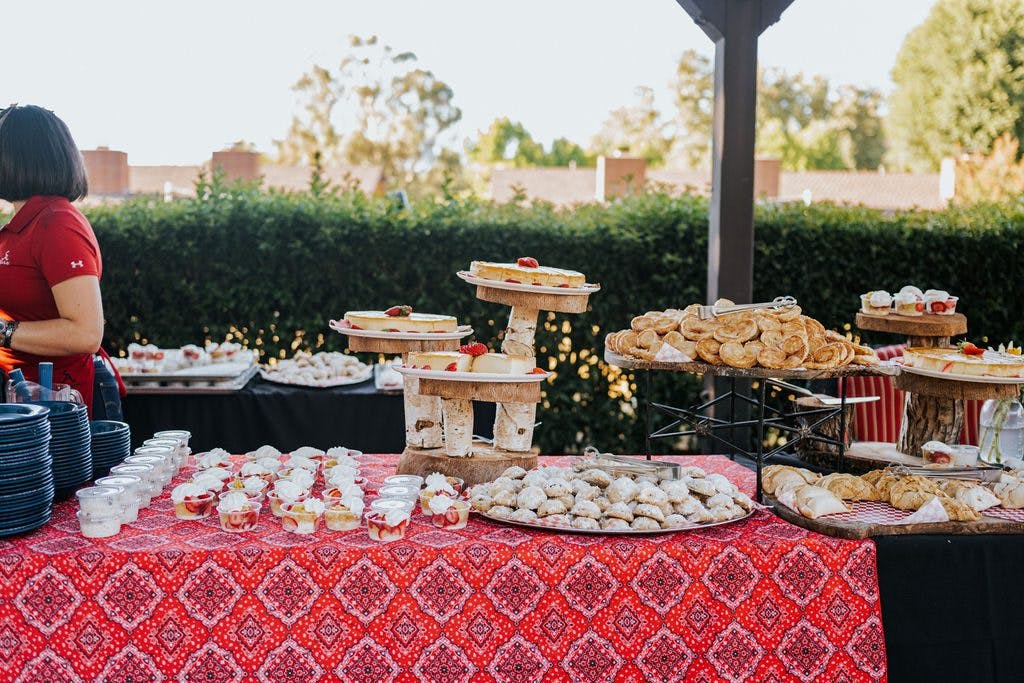 outdoor table setting full of desserts and snacks