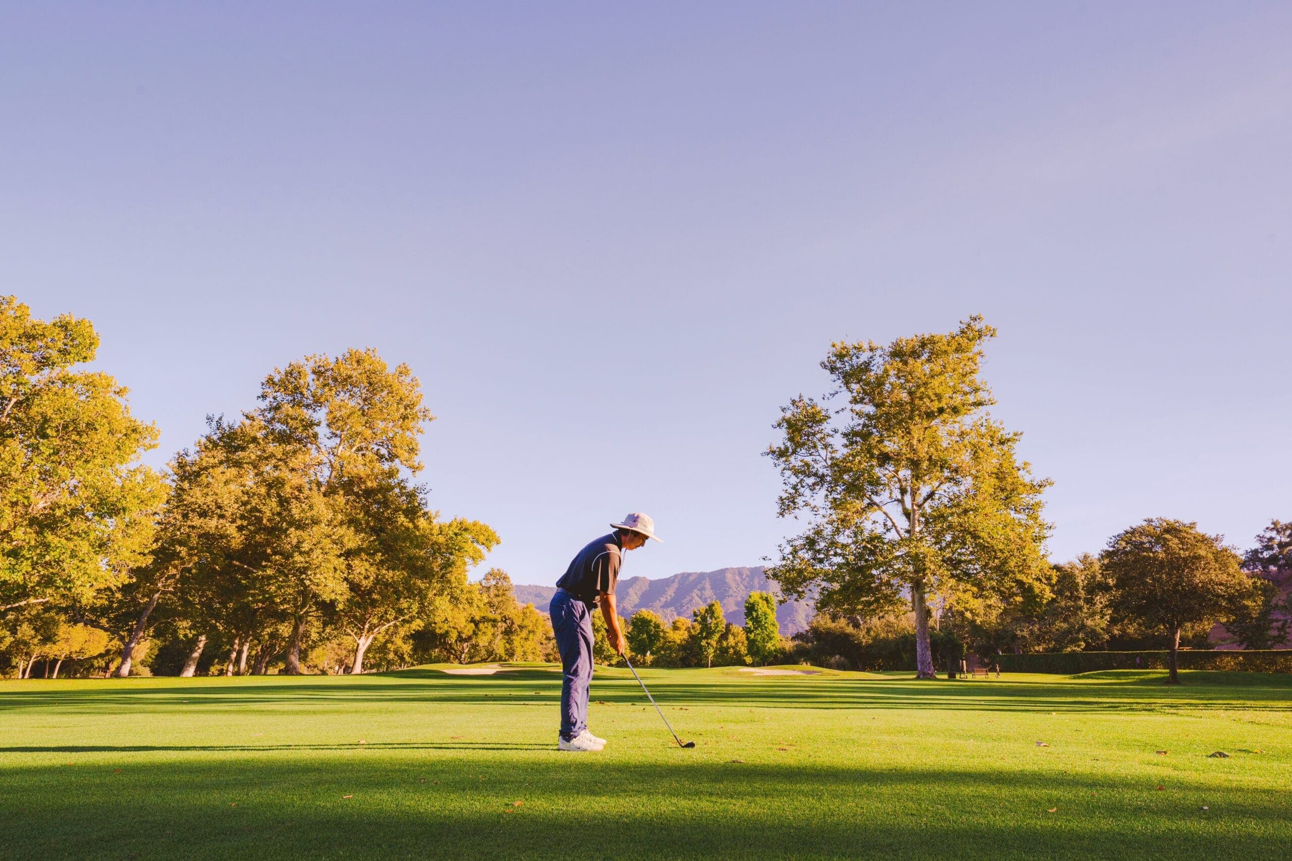 person golfing outdoors