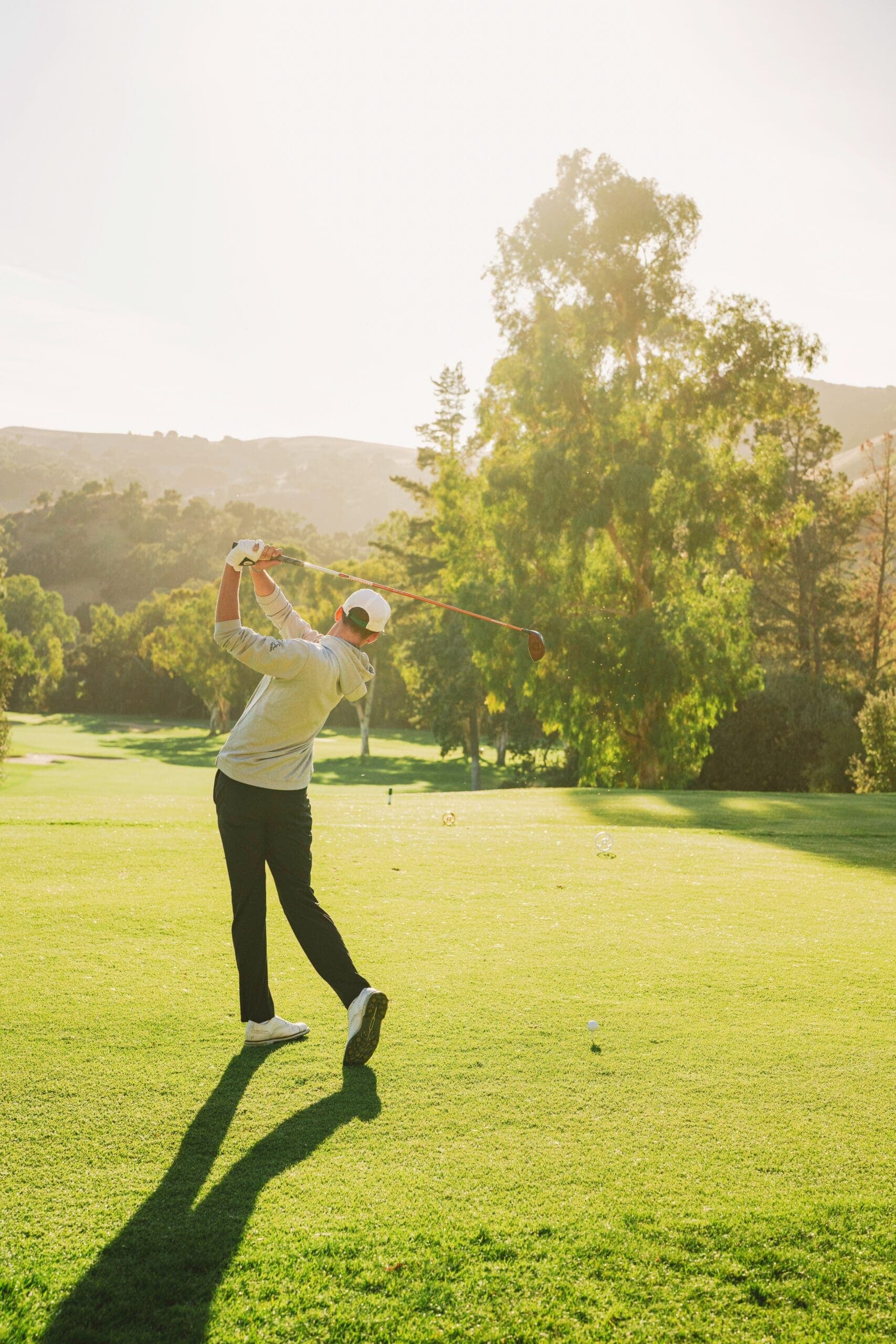 person swinging a golf club