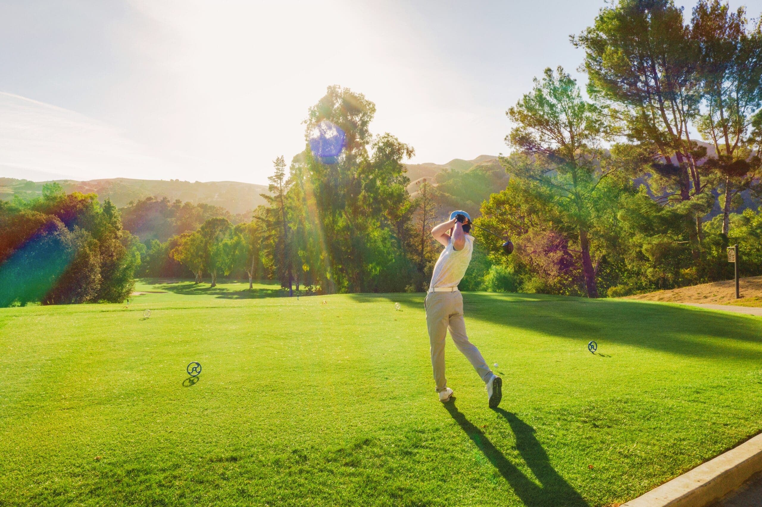 person swinging golf club